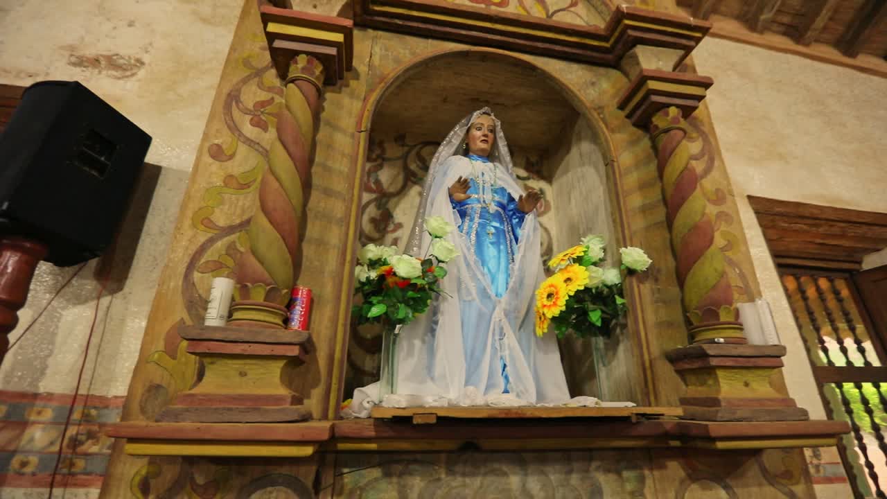 Low angle shot of Virgin Mary statue fixed in the wall of church