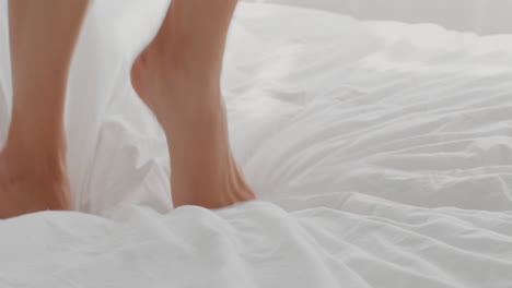 woman's feet getting out of bed