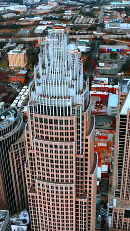 distancing from the top of the beautiful skyscraper. aerial perspective on charlotte downtown, north carolina, usa. vertical video