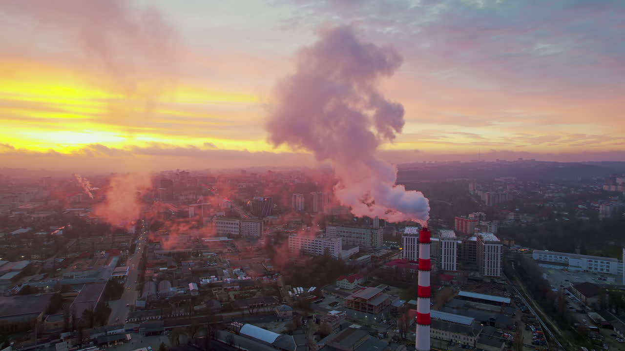 Aerial drone view of thermal power plant in Chisinau at sunrise, Moldova. View of pipes with felling steam, cityscape