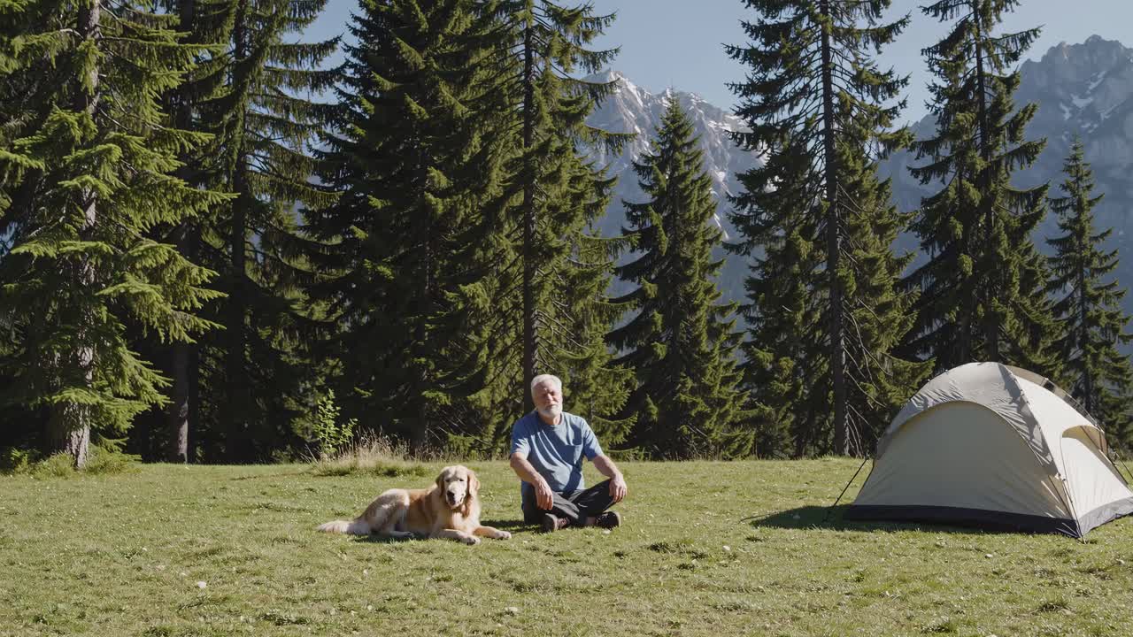 Man and Dog Camping in Mountains