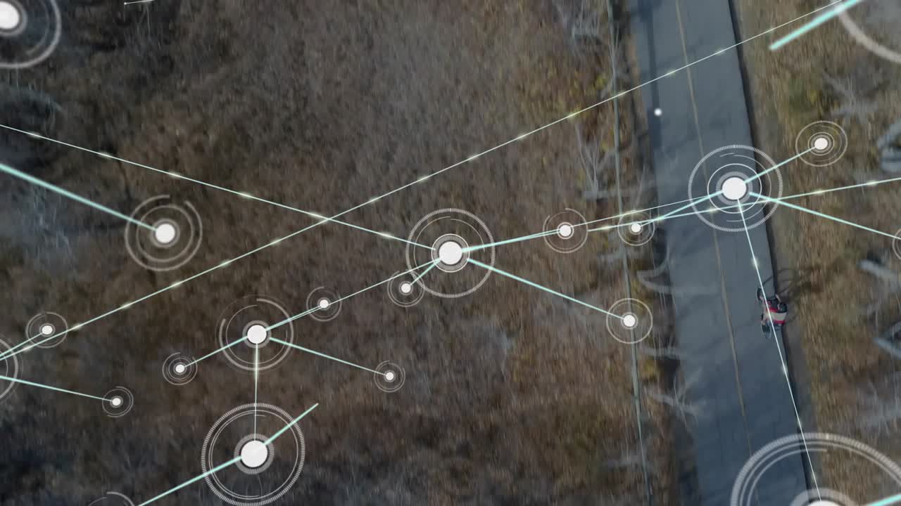 Teen male cycling on paved path, animated nodes appearing over trees and mapping tech network