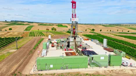 oil and gas drilling rig onshore in austria - aerial drone shot