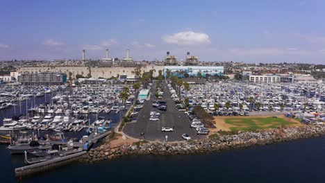 Wide-reverse-pullback-aerial-shot-of-the-boat-landing-at-King-Harbor-Marina-in-Redondo-Beach,-California