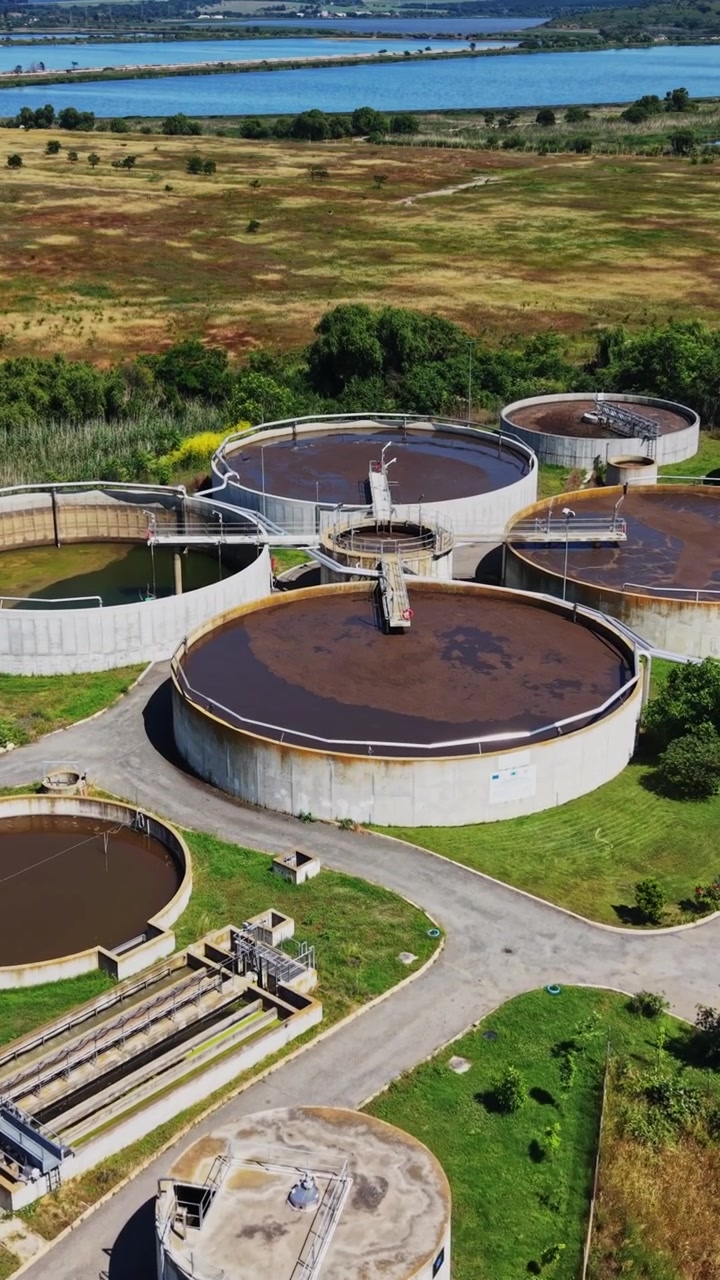 Water treatment facility near river in a green landscape during daytime