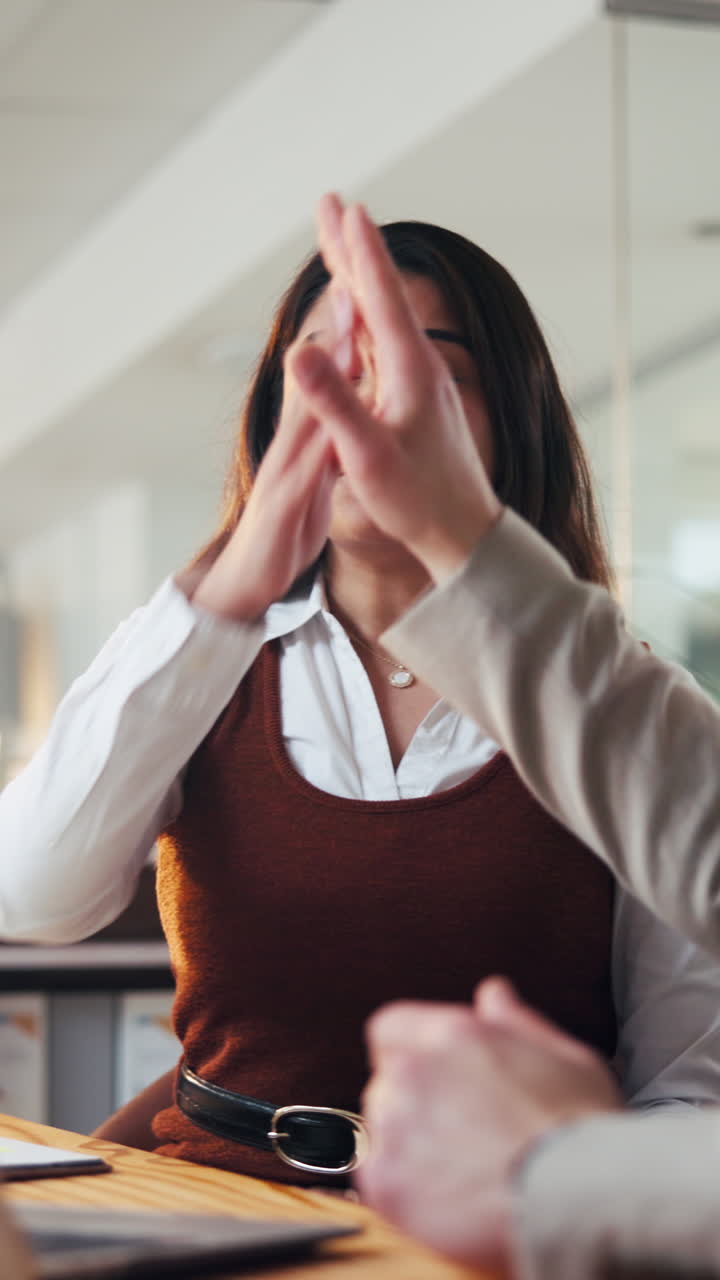 Professional Woman Explaining and Gesturing During a Business Meeting