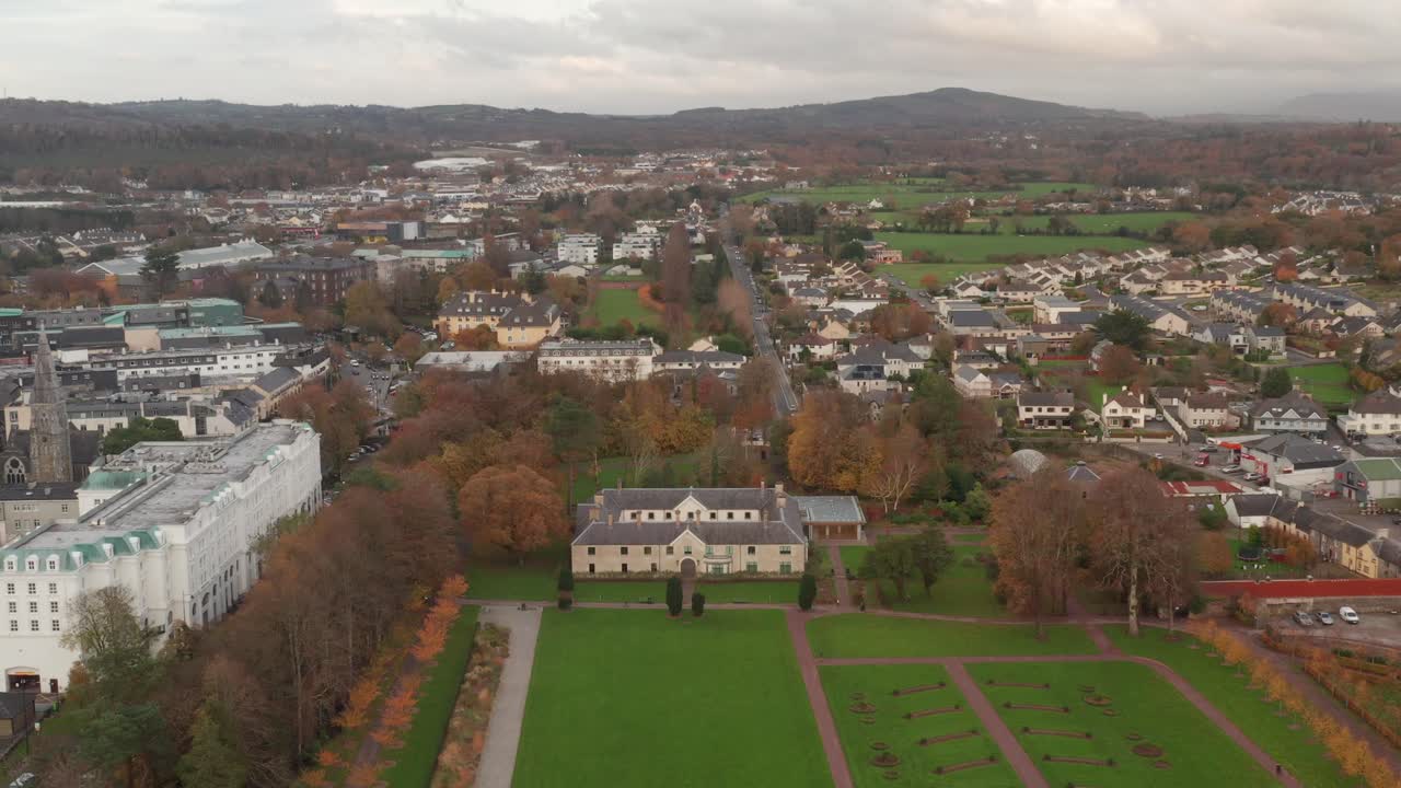 Aerial shot tilting down on Killarney House and Gardens on a foggy fall day in Killarney, Ireland