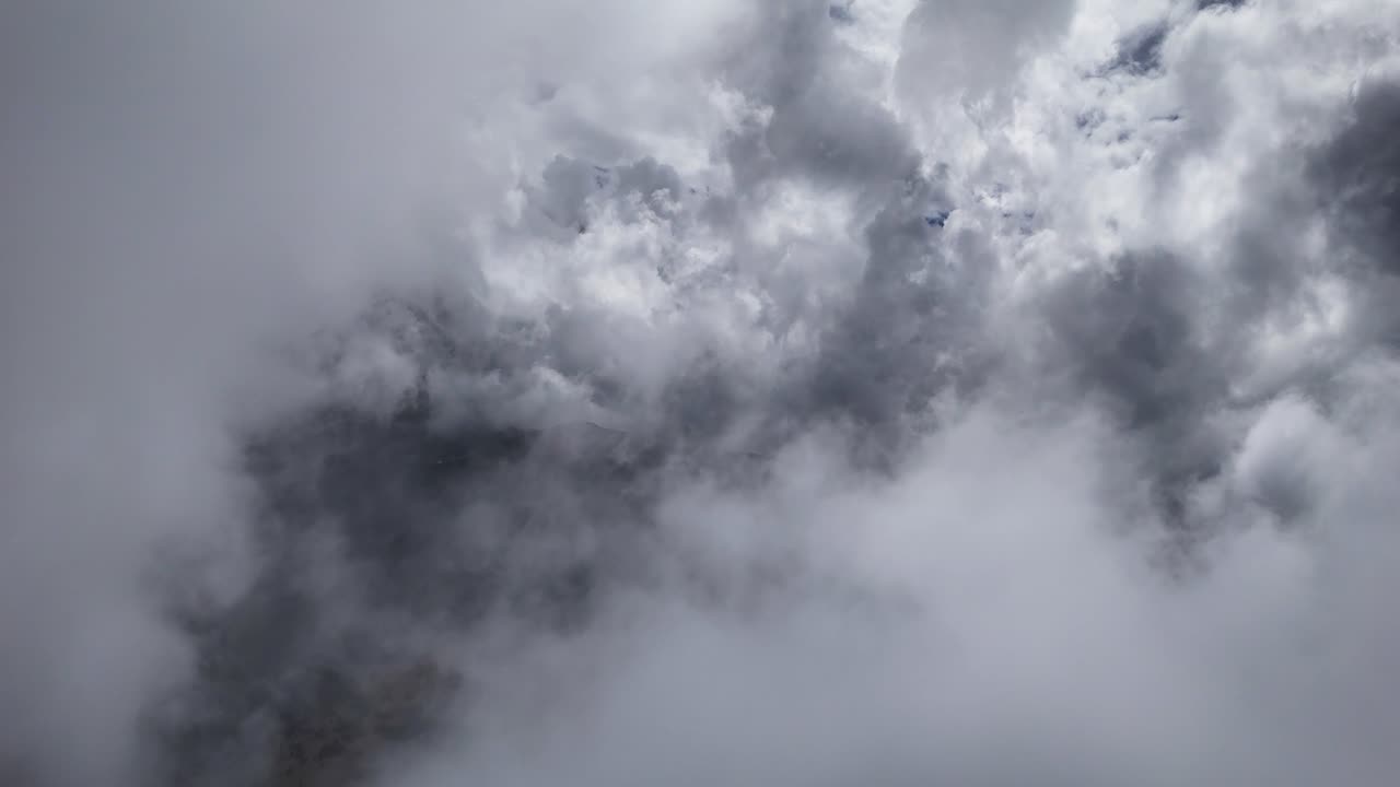 Drone shot flying through a cloud bank over the mountainous pass of Paso de Cortés in the metropolitan area of Mexico City