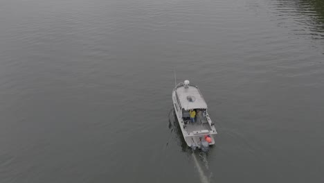 Fishing-boat-on-calm-ocean-water-on-the-west-coast-top-down