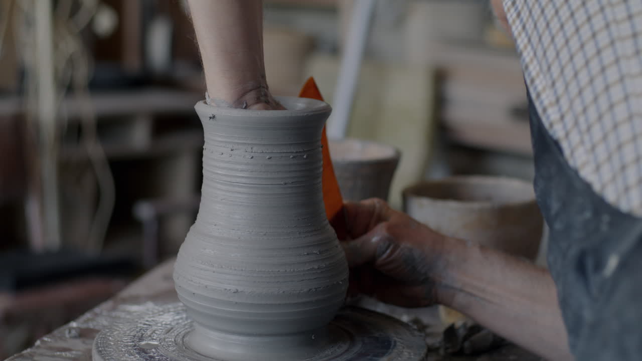 Pottery Artist Shaping a Vase on a Wheel