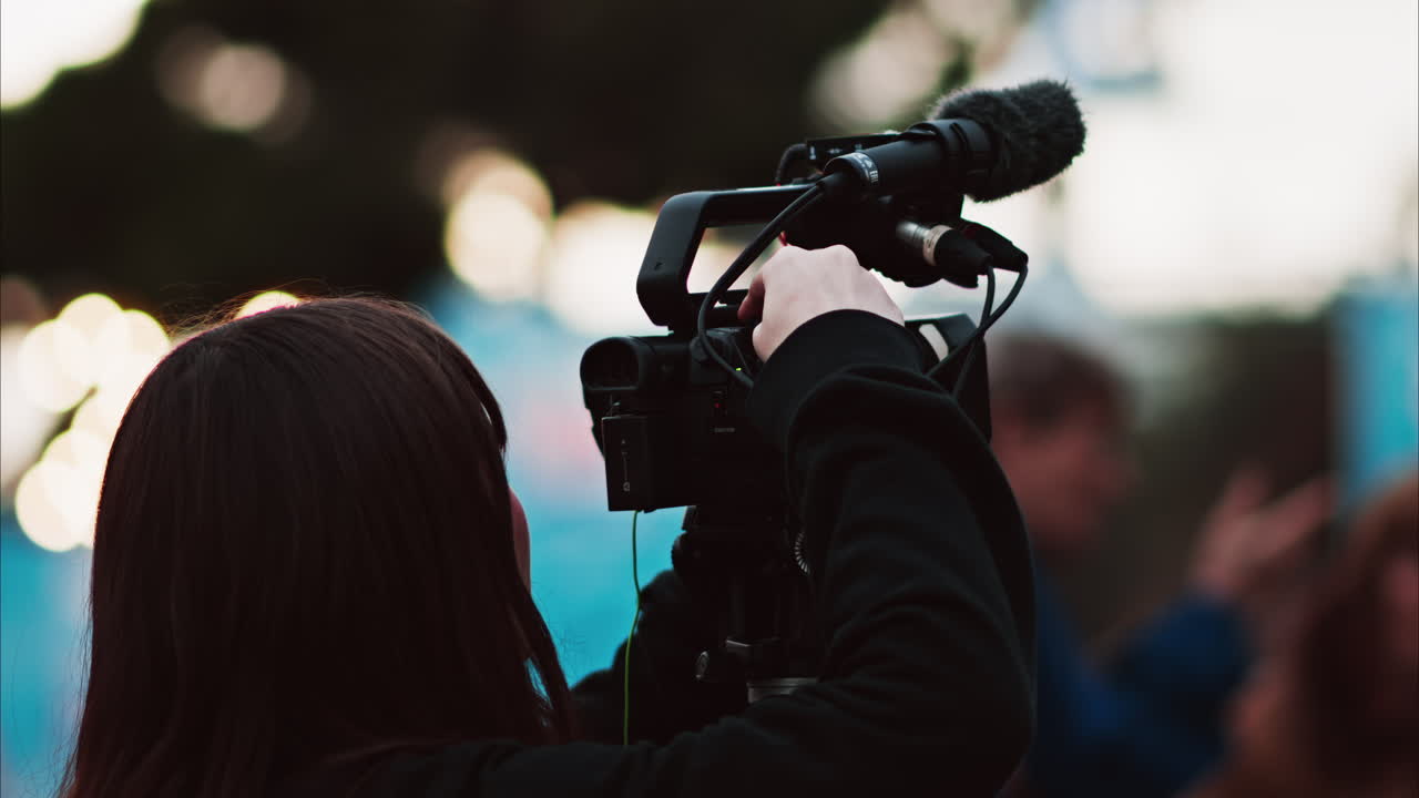 Nice, France - December 14, 2024: Two girls filming people walking through Place Massena in daylight