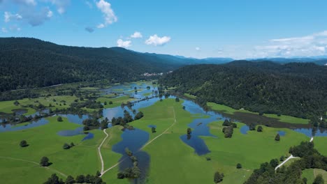 beautiful aerial panoramic of cerknica intermittent lake in valley and mountain surroundings