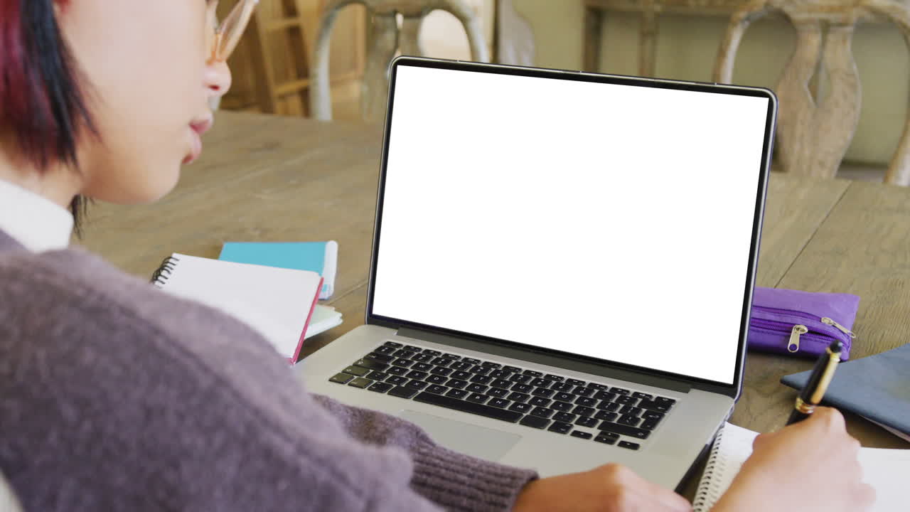 Asian female student having class on laptop video call with copy space in slow motion