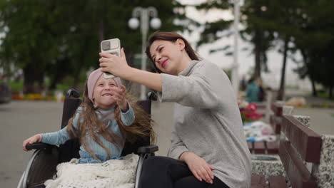 toothless girl makes videos with mom waving hello in camera