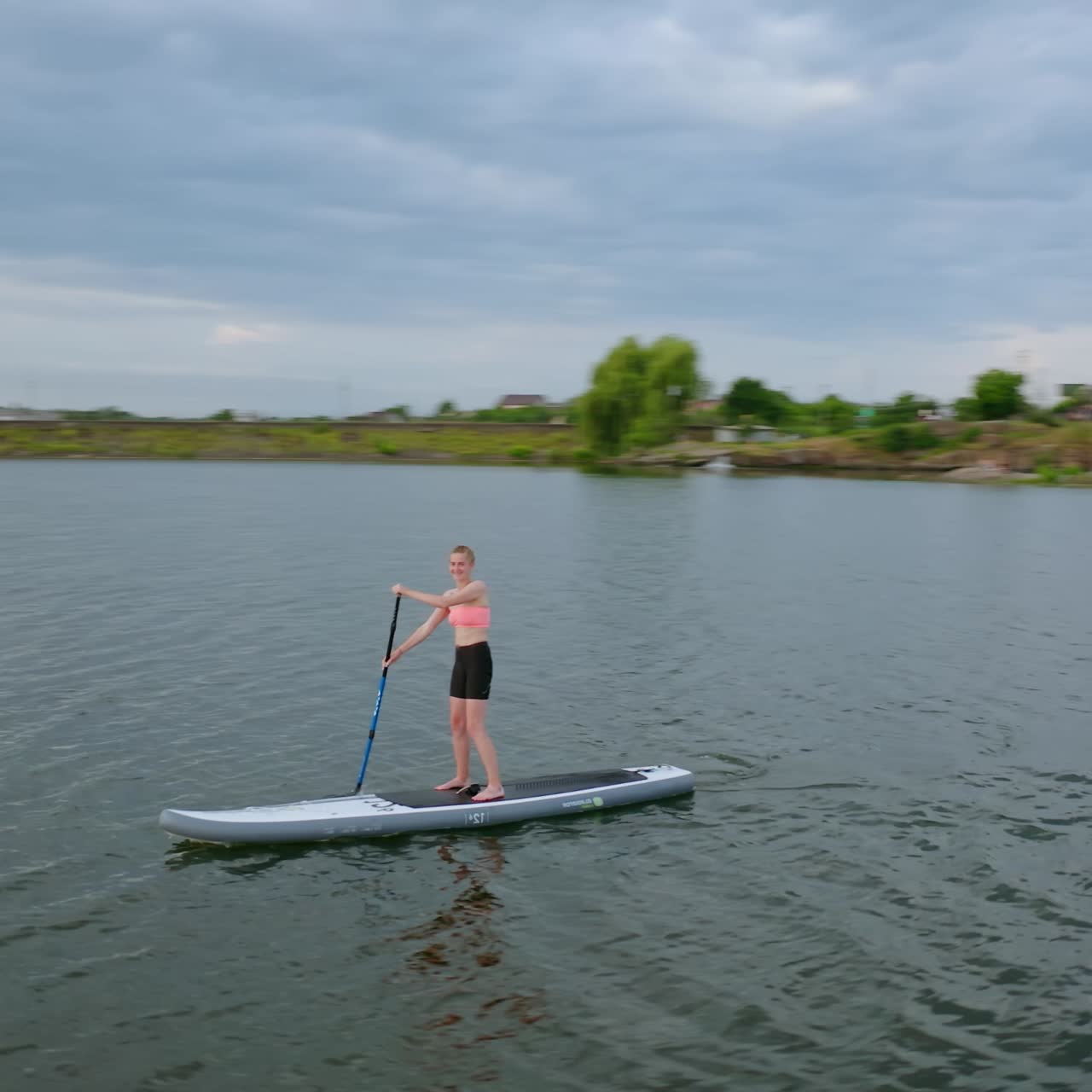 People Floating Standup Paddle Board. People standing on sup board and swims surfing on the river