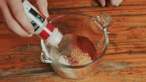 adding marination spices for chicken leg preparation