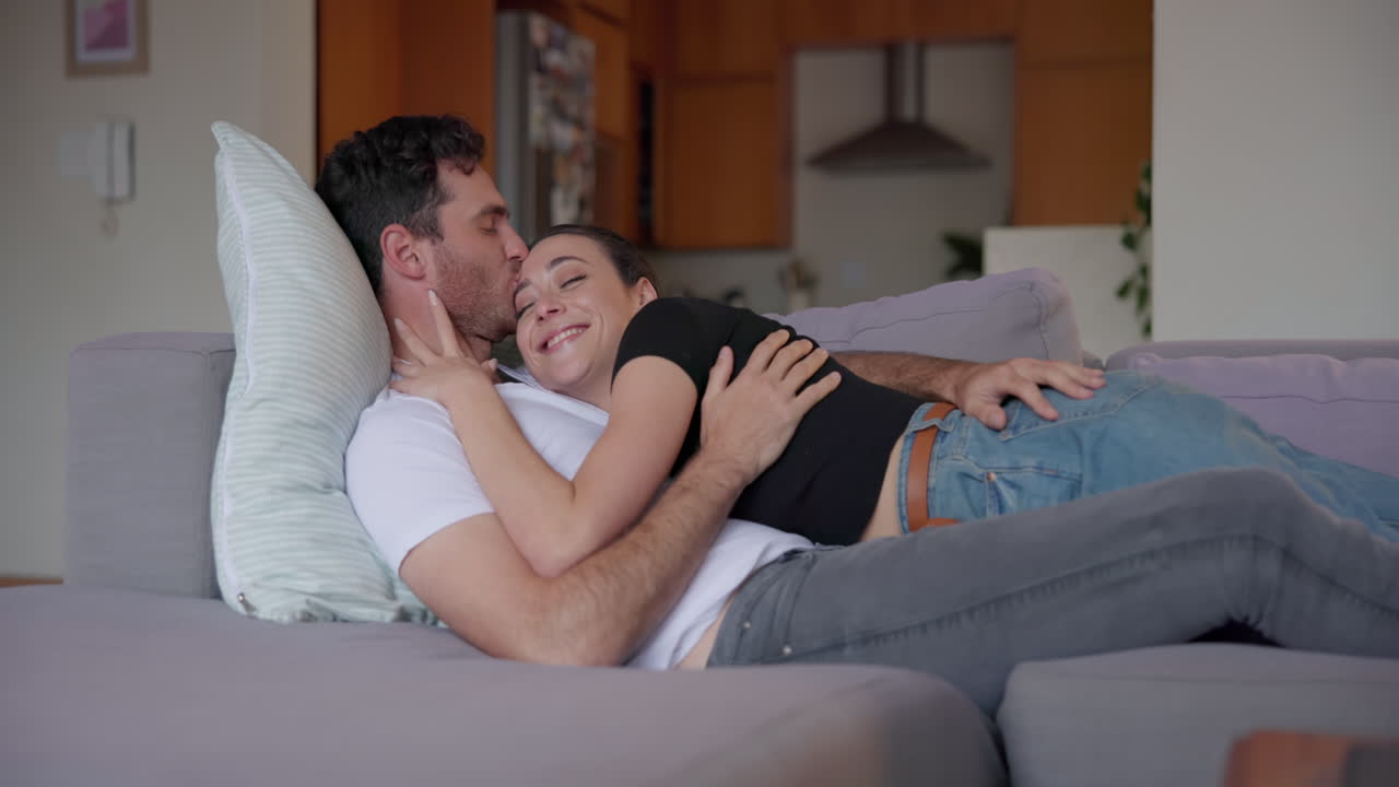 Couple, hug and lying on sofa for love | Premium Stock Video Footage