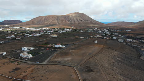 traditional la oliva town old windmill aerial view rising over scenic volcanic mountain landscape of fuerteventura