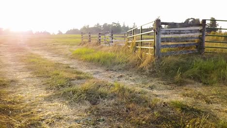 Aerial-of-an-old-farm-gate-during-a-sunset