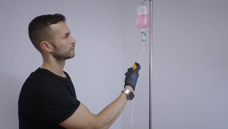 man interacting with an iv drip
