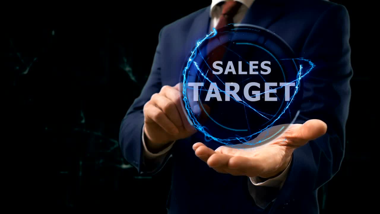 Businessman shows concept hologram Sales target on his hand
