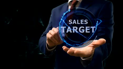 businessman shows concept hologram sales target on his hand