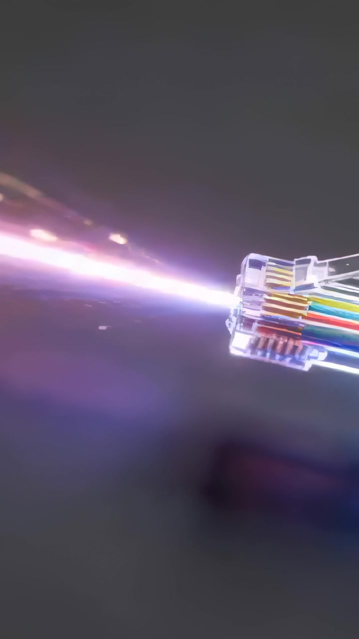 Vertical video: Emitting clear RJ45 with wires sending data beam with sparks on gray, copy space