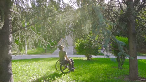 Disabled-young-man-sitting-in-his-wheelchair-in-nature-in-slow-motion.