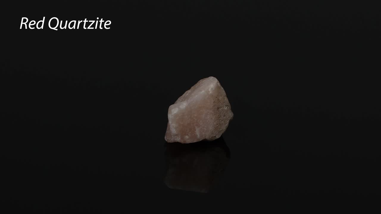 A red quartzite rock rotating on a black surface | Premium Stock Video ...