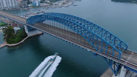 a-fishing-boat-passing-under-a-bridge-at-high-speed