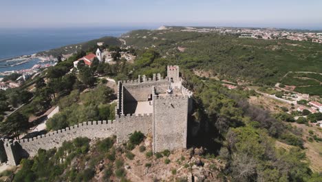 aerial orbiting over sesimbra castle watching tower, scenery viewpoint  - portugal