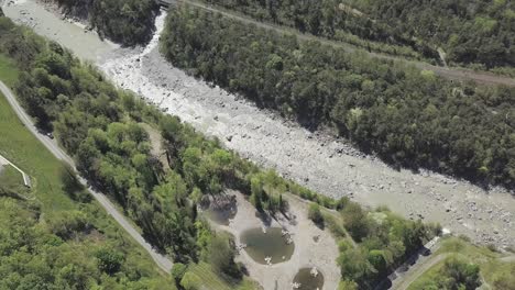 aerial drone shot overlooking the rhone river over flowing through switzerland