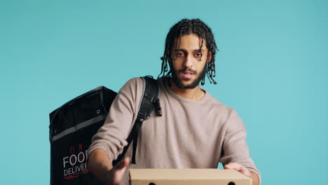 Portrait-of-BIPOC-courier-delivering-pizza-order-to-client,-camera-background