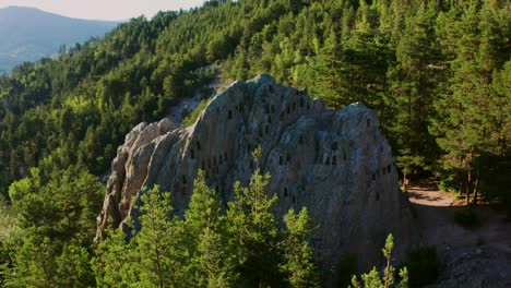 Drone-orbiting-around-the-natural-rock-formation-of-a-sacrificial-altar-of-Eagle's-Rock,-or-locally-known-as-the-Orlovi-Skali,-located-in-Rhodope-Mountains-in-Bulgaria