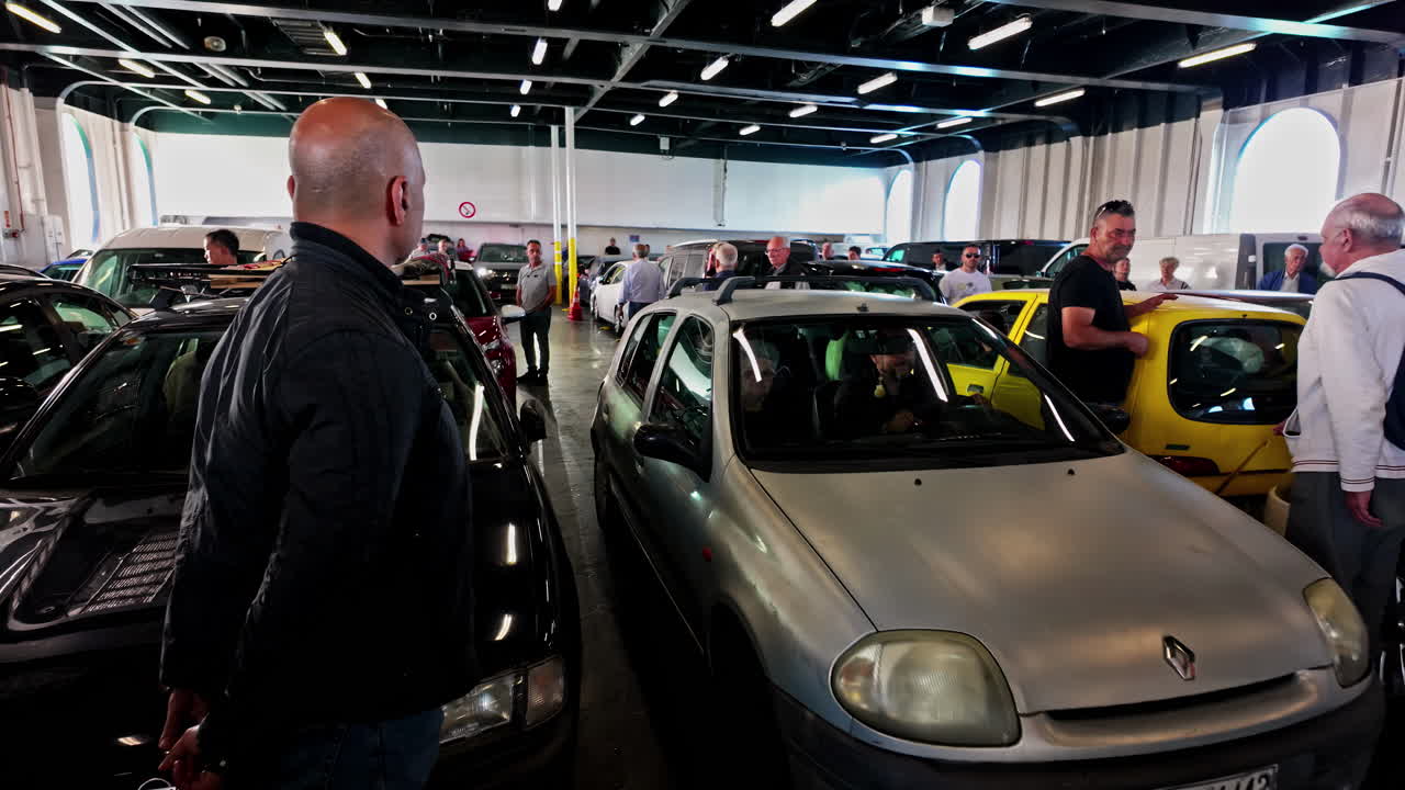 Cars and people on a car ferry deck