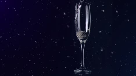 animation of white specks floating over glass of champagne on black background