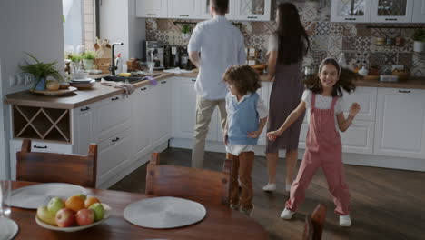 family dancing in kitchen