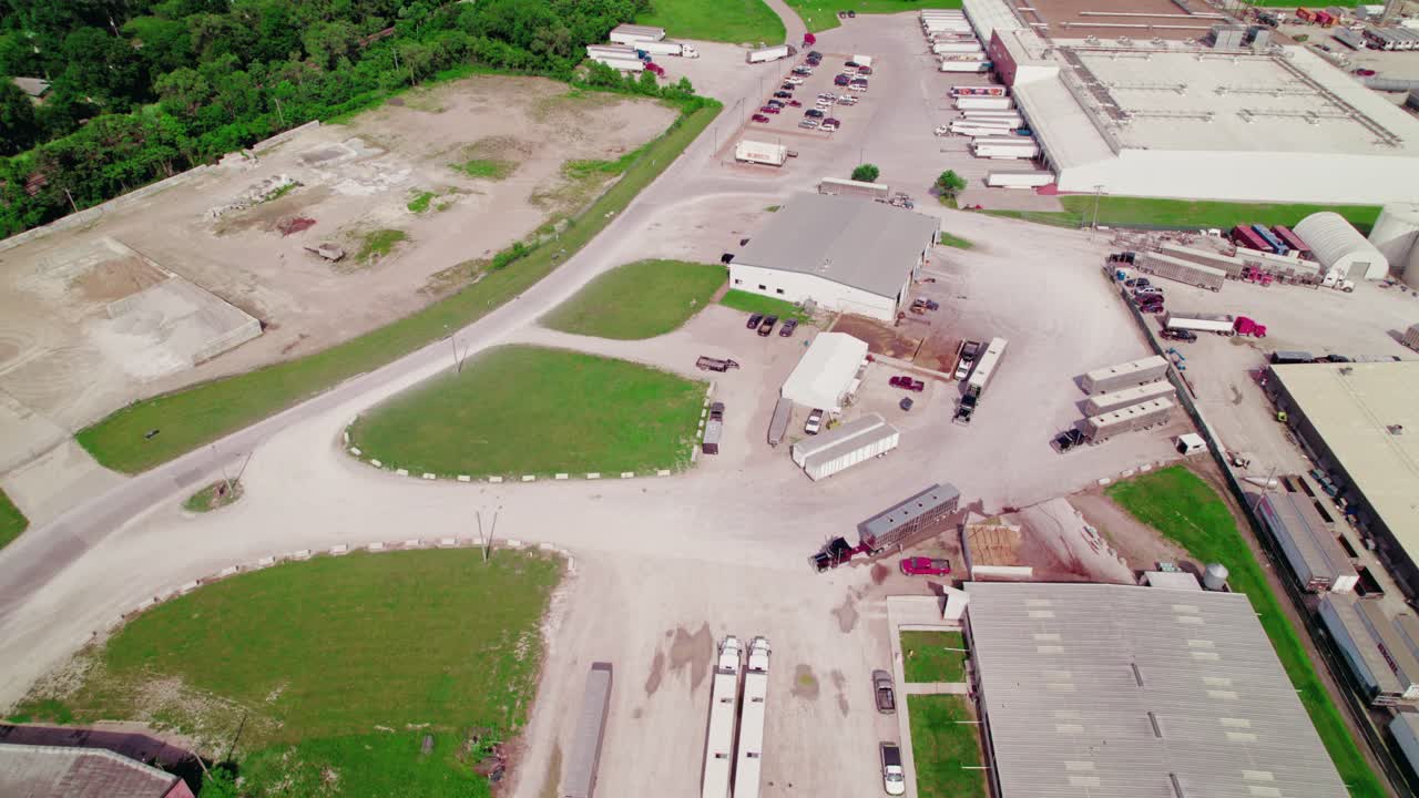 Aerial View of a Large Industrial Complex with Numerous Trucks