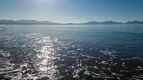 slow motion tide waves splashing under heavenly hazy sunrise snowdonia anglesey mountain range skyline