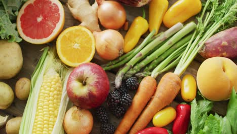 video of fresh fruit and vegetables over wooden background