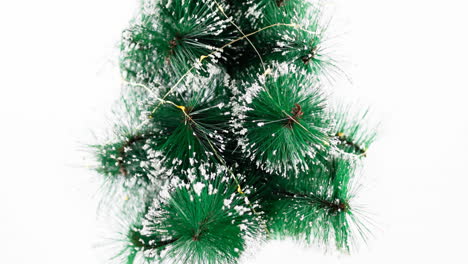 animation of christmas baubles and tree on white background