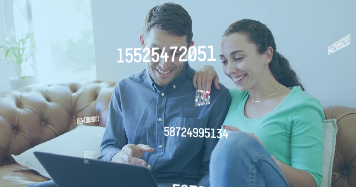 Coppia che usa il laptop insieme sul divano con sovrapposizione di dati digitali.