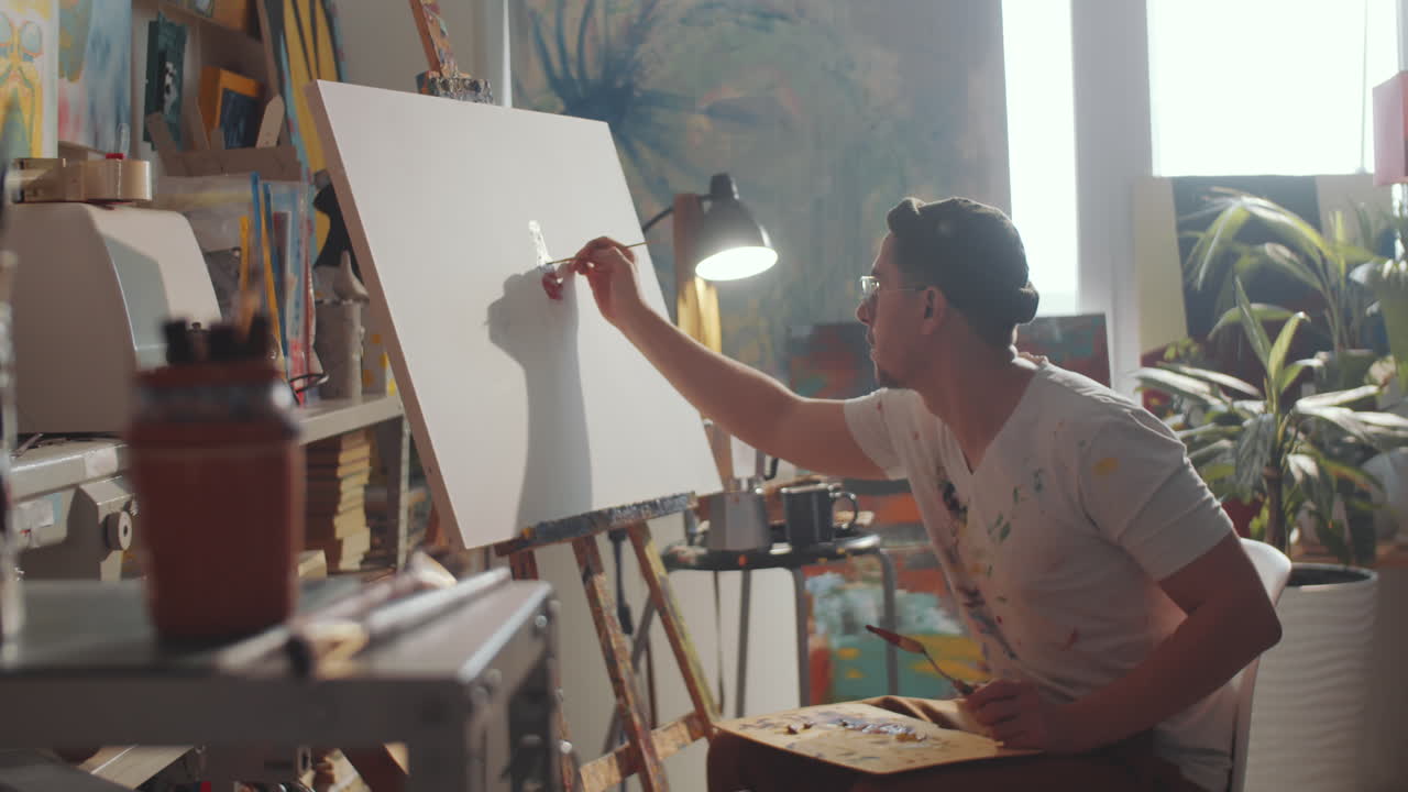 Young Man Painting Picture in Creative Studio
