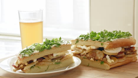 a beautiful shot of sandwich and a beer in a kitchen