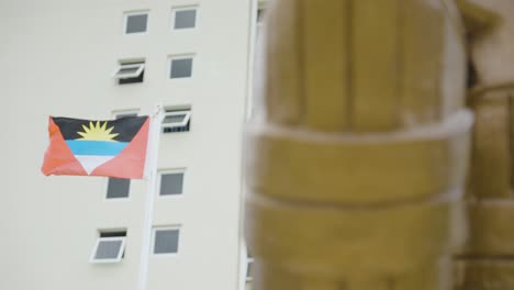 rack focus from a cricket pad statue to the antigua flag, at viv richards stadium