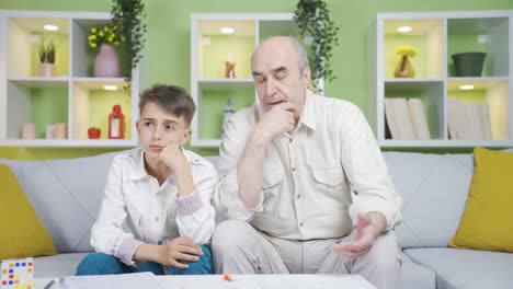 Grandfather-and-grandson-thinking-about-a-topic.-They-consult.