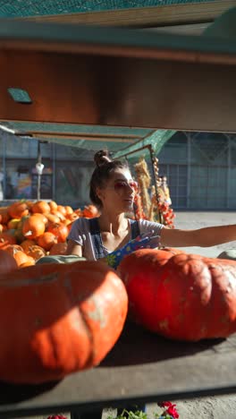 woman at a fall pumpkin market