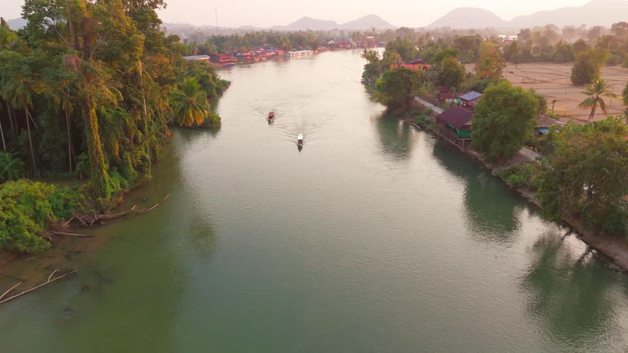 Drone fly above 4000 Islands Laos, Boats sail Tropical Southeast Asian landscape