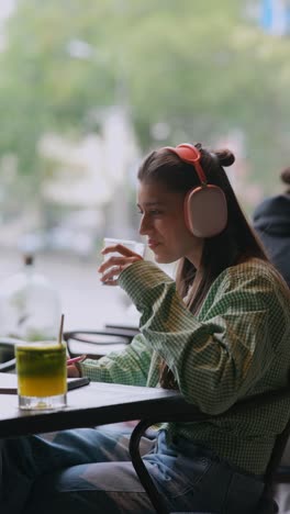 woman relaxing and working in cafe