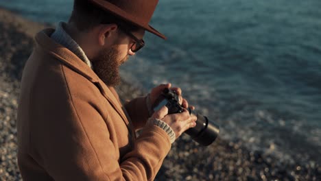 man taking pictures on the beach